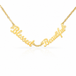 A gold script affirmation nameplate necklace reading 'Blessed Beautiful' on a delicate gold chain, shown against a clean white background with a soft reflection below.