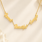 A gold script affirmation necklace spelling out 'Loved Beautiful Enough' in cursive script, displayed on a soft, light beige fabric background.