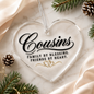 A clear heart-shaped acrylic ornament with black script reading 'Cousins' and the phrase 'Family by blessing. Friends by heart.
