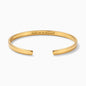 A polished gold-tone open cuff bracelet with 'Your Text Here' engraved on the inside, displayed on a clean white background.