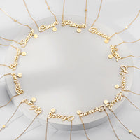 Load image into Gallery viewer, A gold-colored necklace with zodiac sign engravings and small zircon stones, displayed on a circular silver stand.
