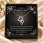A silver double-heart pendant necklace displayed inside a black gift box with sentimental message card, set on a beige satin fabric background.
